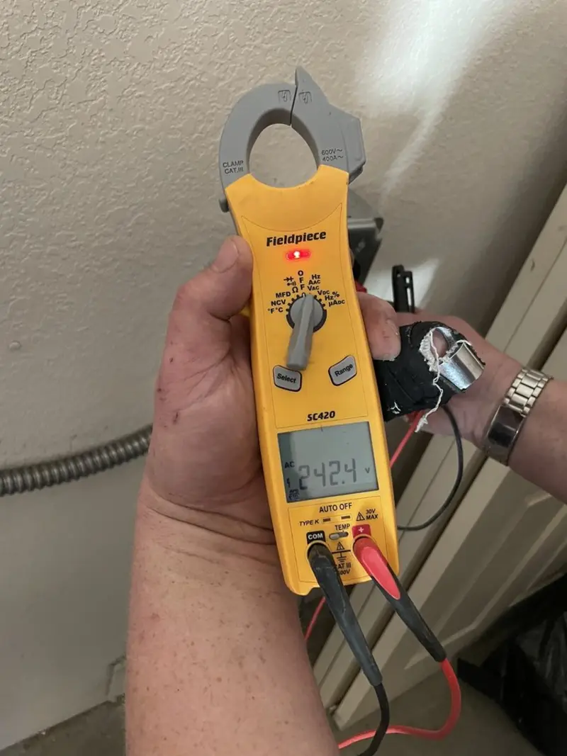 Voltage testing with clamp meter during Whole House Surge Protector in South Brunswick